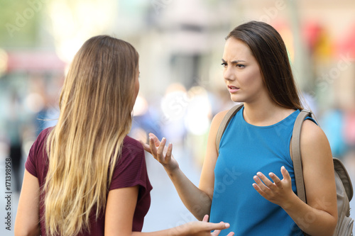Принти на полотні Two friends talking seriously on the street