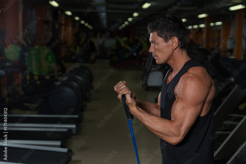 Muscular athlete training in fitness club Muscular athlete training in fitness club