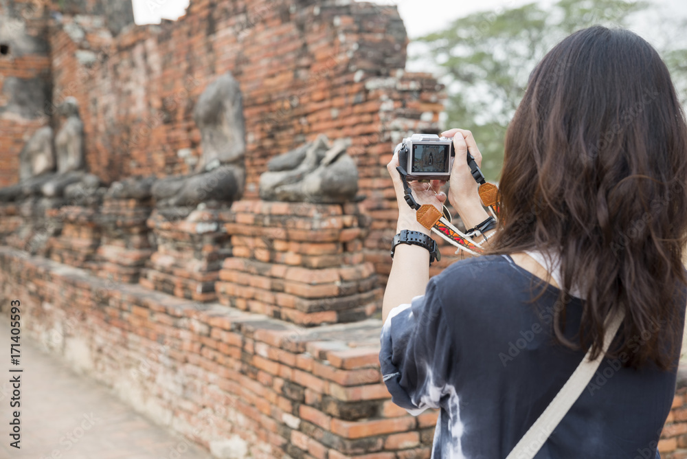 People back view,photographer woman take photo Old Buddha at Wat Phra Sri Sanphet temple,Ayutthaya,Thailand.Asian traveler female sightseeing with mirrorless camera.Travel and Photographer concept. People back view,photographer woman take photo Old Buddha at Wat Phra Sri Sanphet temple,Ayutthaya,Thailand.Asian traveler female sightseeing with mirrorless camera.Travel and Photographer concept.