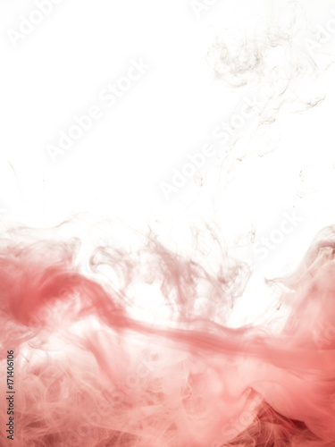 Red ink swirl in water isolated on white background. The paint in the water. Soft dissemination a droplets of ink in water close-up. Abstract vertical photo with soft focus, blurred backdrop