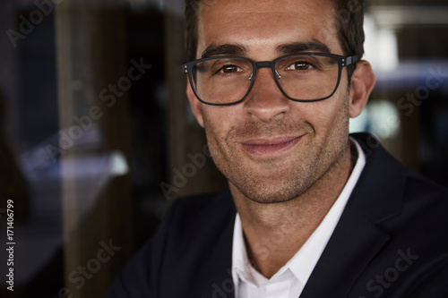 Handsome smiling man in spectacles, close up