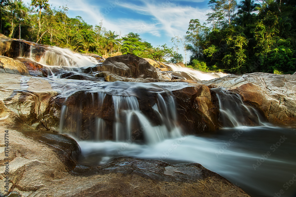 Fototapeta premium Small waterfall and stone with water motion.