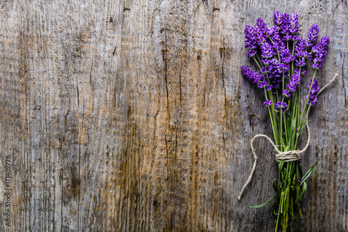 Lavender flowers, bouquet on wooden background, top view
