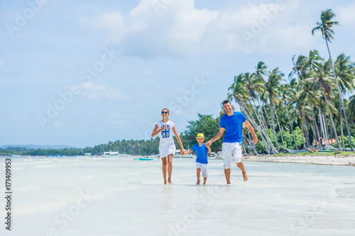 Family of three having fun at the beach © Max Topchii