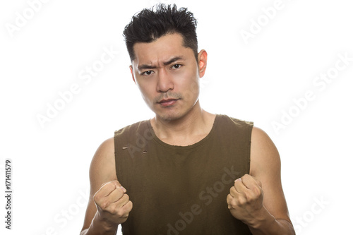 Fotografie Athletic Asian male with trendy torn sleeveless shirt on a white background
