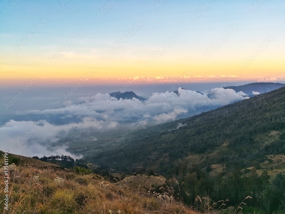 Fototapeta premium sea of cloud on the top of mountain. Beautiful nature in sunset time. 