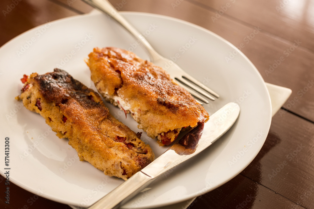 Grilled and fried in eggs paprika with knife and fork on the pla Grilled and fried in eggs paprika with knife and fork on the pla