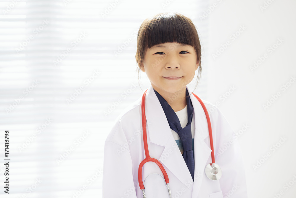 Portrait of little girl dressed as a doctor with a stethoscope . Portrait of little girl dressed as a doctor with a stethoscope .