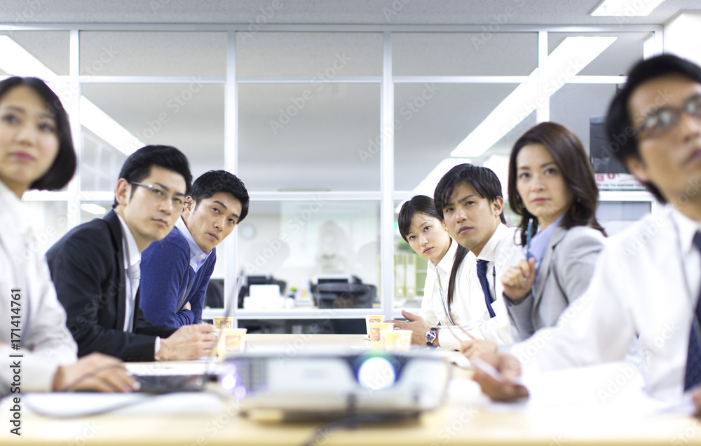 Business people looking at presentation on a projector Business people looking at presentation on a projector