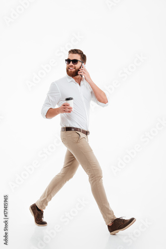 Handsome young bearded man drinking coffee