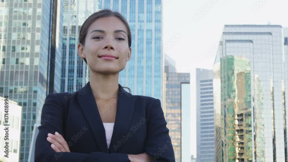Business woman portrait of young female urban professional businesswoman in suit with arms crossed in Downtown Vancouver, BC, Canada. Confident successful multicultural Chinese Asian / Caucasian woman Business woman portrait of young female urban professional businesswoman in suit with arms crossed in Downtown Vancouver, BC, Canada. Confident successful multicultural Chinese Asian / Caucasian woman
