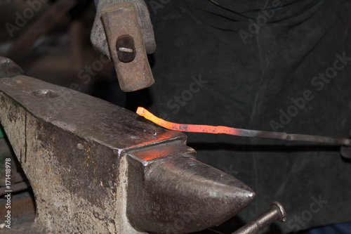 Making the horseshoe from heated red rod