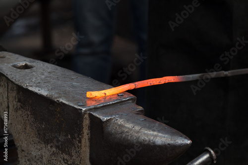 Making the horseshoe from heated red rod