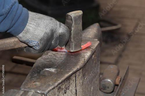 Making the horseshoe from heated red rod