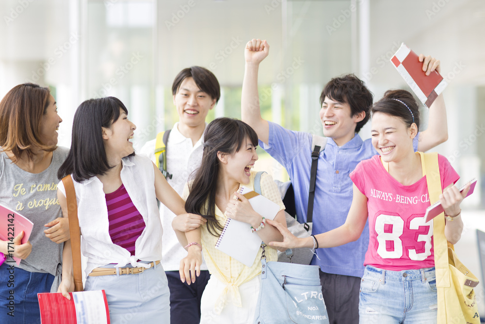 Six College Students Smiling and Walking into Entrance Hall Six College Students Smiling and Walking into Entrance Hall