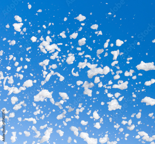 White foam against the blue sky as background