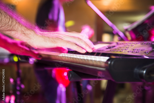 Musician plays keyboards in a rock band