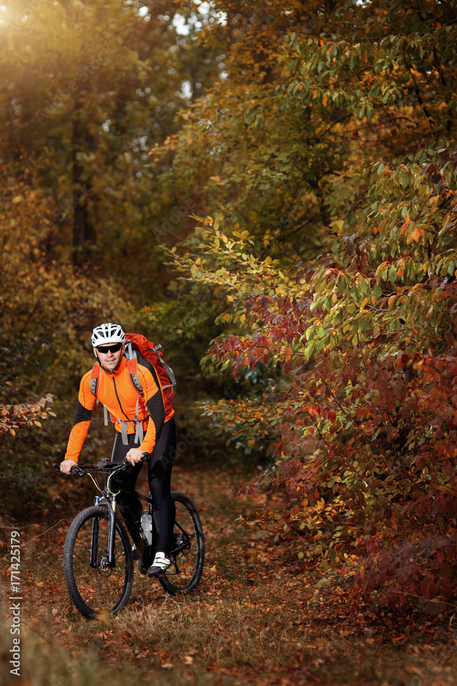 Mountain biking down the trail. Tourist with backpack travel on bike. Mountain biking down the trail. Tourist with backpack travel on bike.