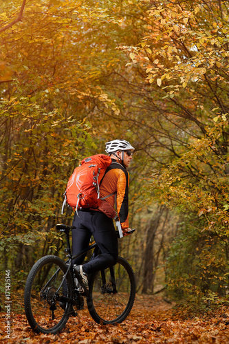 Mountain biking down the trail. Tourist with backpack travel on bike.
