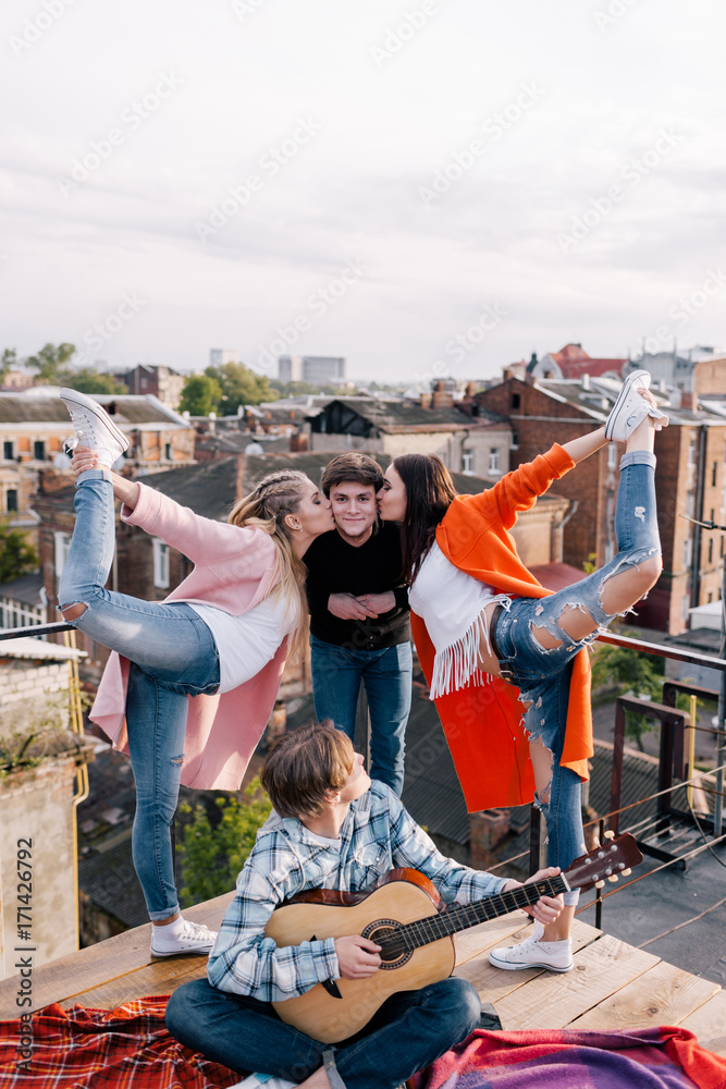 Fototapeta premium Friends party on roof. Happy leisure time. Sport and music for young people, funny pastime outdoors