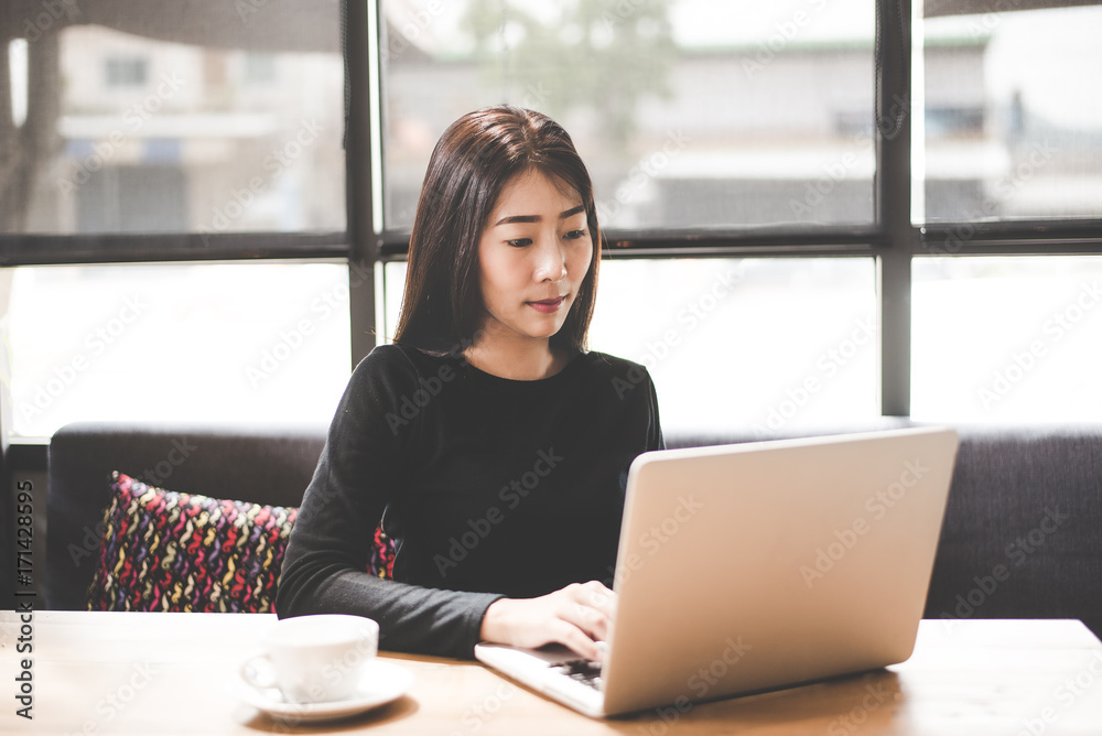 Business asian women using tablet computer to work with financial data in the work space. Business Concept. select focus Business asian women using tablet computer to work with financial data in the work space. Business Concept. select focus