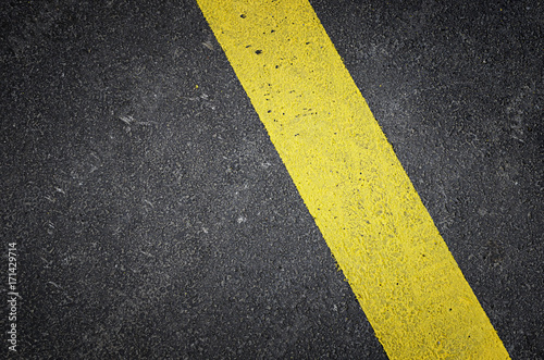 Asphalt road background with yellow line © NatasaAdzic