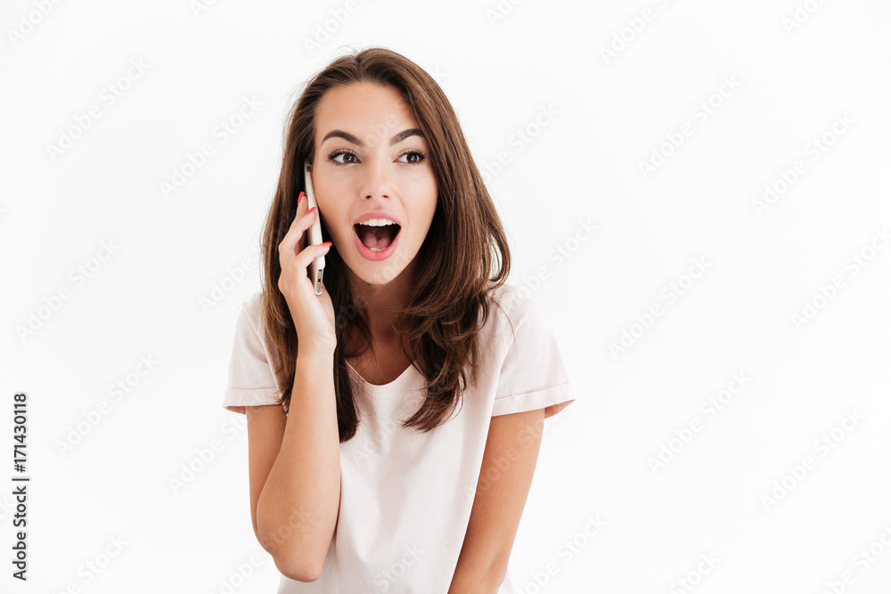 Surprised happy talking on smartphone and looking away Surprised happy talking on smartphone and looking away