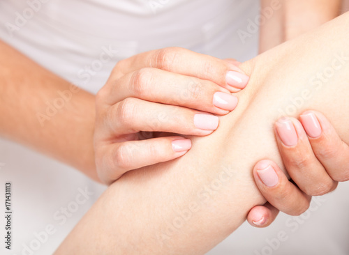 Woman receiving osteopathic treatment of her elbow