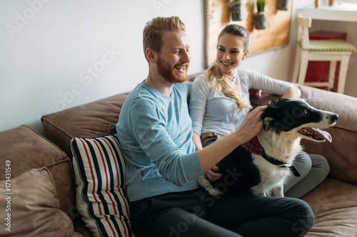 Beautiful couple relaxing at home and loving their dog © NDABCREATIVITY