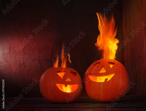 Halloween pumpkins on wooden table on dark background
