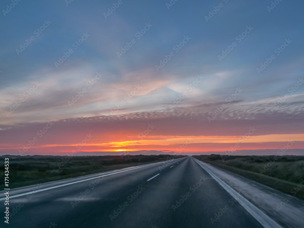Highway on a cold autumn morning with a beautiful sunrise