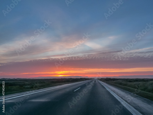 Highway on a cold autumn morning with a beautiful sunrise © Angela Rohde