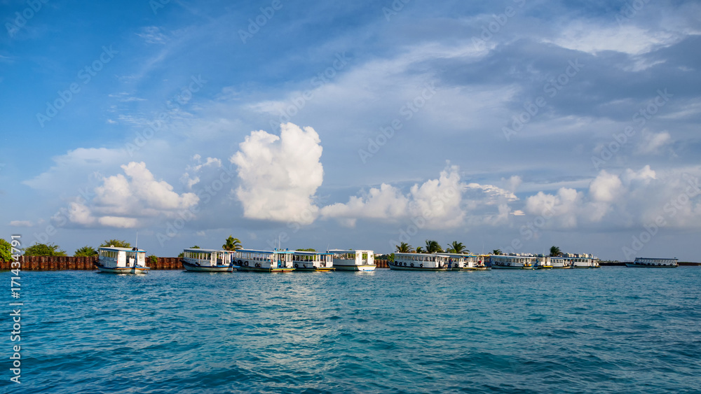 Local tourist boat in the harbor in city Male, capital of Maldives.