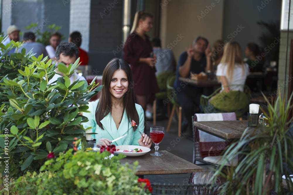 Young beautiful brunette woman бsitting in a restaurant Young beautiful brunette woman бsitting in a restaurant