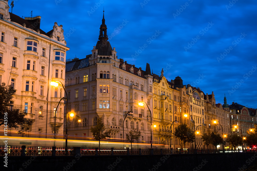 Prague, Czech Republic / Czechia - beautiful and decorated historic townhouses at Masaryk embankment are made in secession style. Residential architecture and lanterns during night