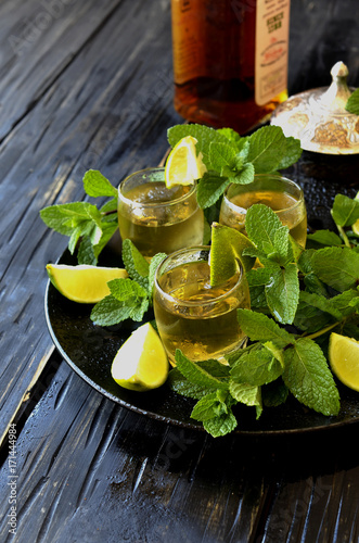 Glass of whiskey with mint and lemon