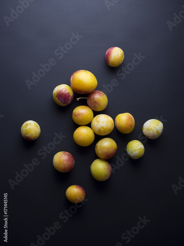 Fresh mirabelles plums isolated on black background