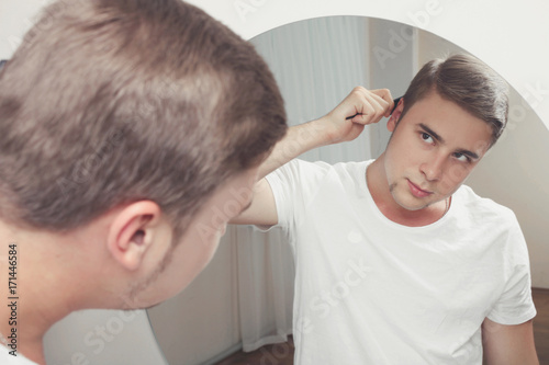 man combing his hair