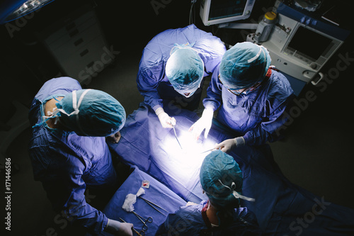 Team of surgeons performing surgery in operation theater photo