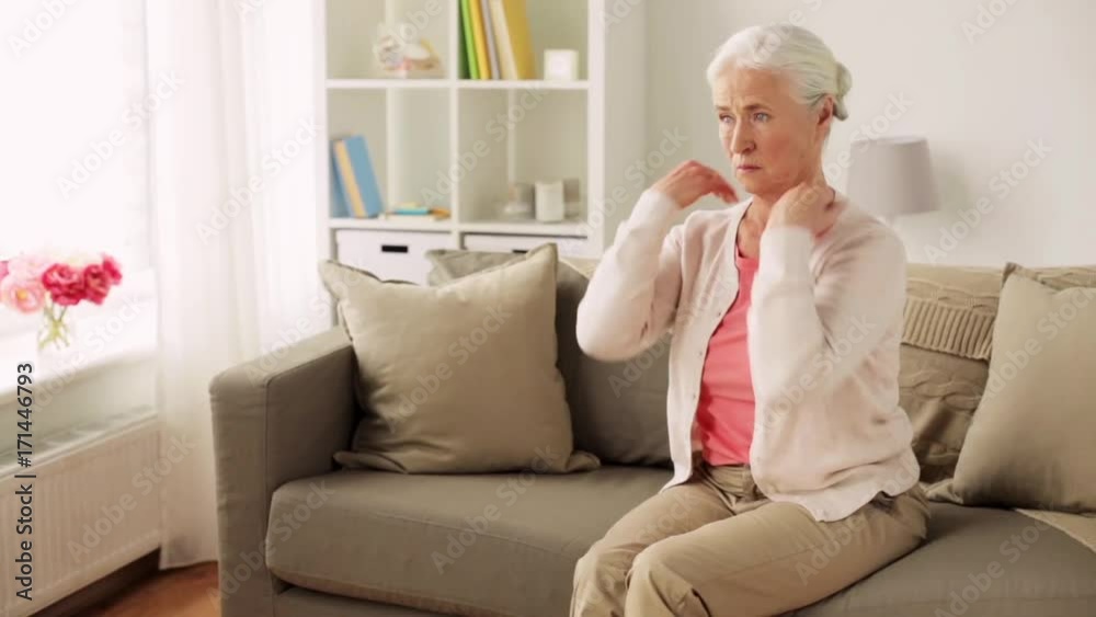 senior woman suffering from neck pain at home senior woman suffering from neck pain at home