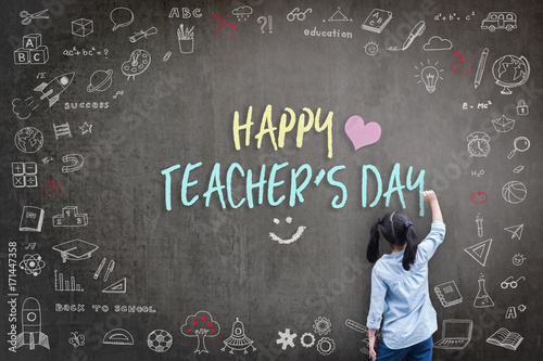 Happy Teacher's Day greeting for World teachers day concept with school student back view drawing doodle of of learning education graphic freehand illustration icon on black chalkboard photo