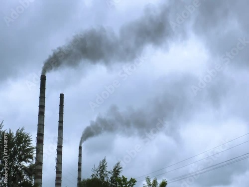 Pipes of thermal power plant are emitting smoke.