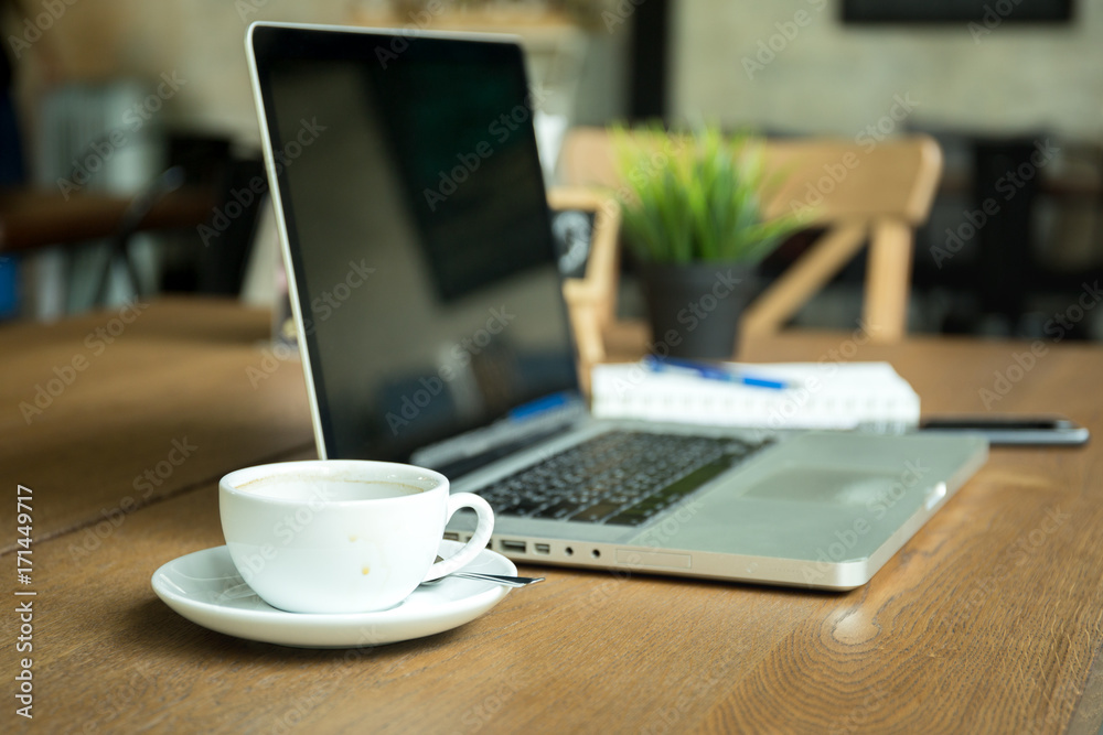 cup of coffee with notebook and cell phone cup on wooden desk cup of coffee with notebook and cell phone cup on wooden desk