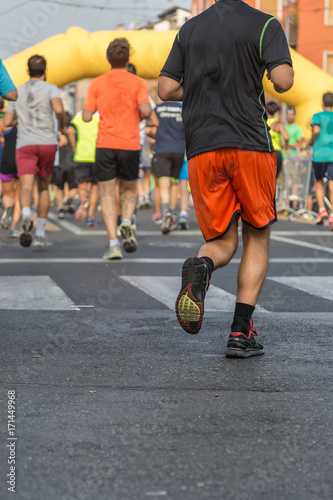 People Running in City Marathon: Rear View