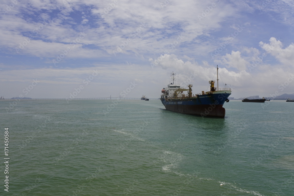 A ship was docked in front of Penang Bridge, Penang, Malaysia A ship was docked in front of Penang Bridge, Penang, Malaysia