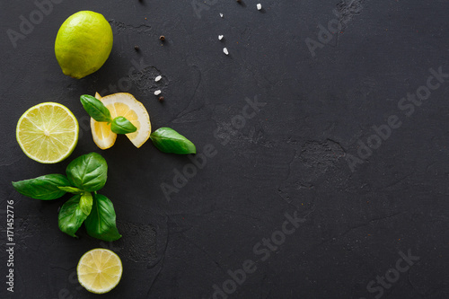 Lime and lemon with mint on black background