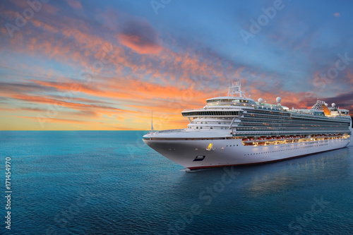 Fototapeta Luxury cruise ship sailing to port on sunrise