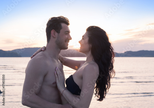 Couple On Beach Summer Vacation  Beautiful Young Happy People In Love  Man And Woman Smile Sea Ocean Holiday Travel