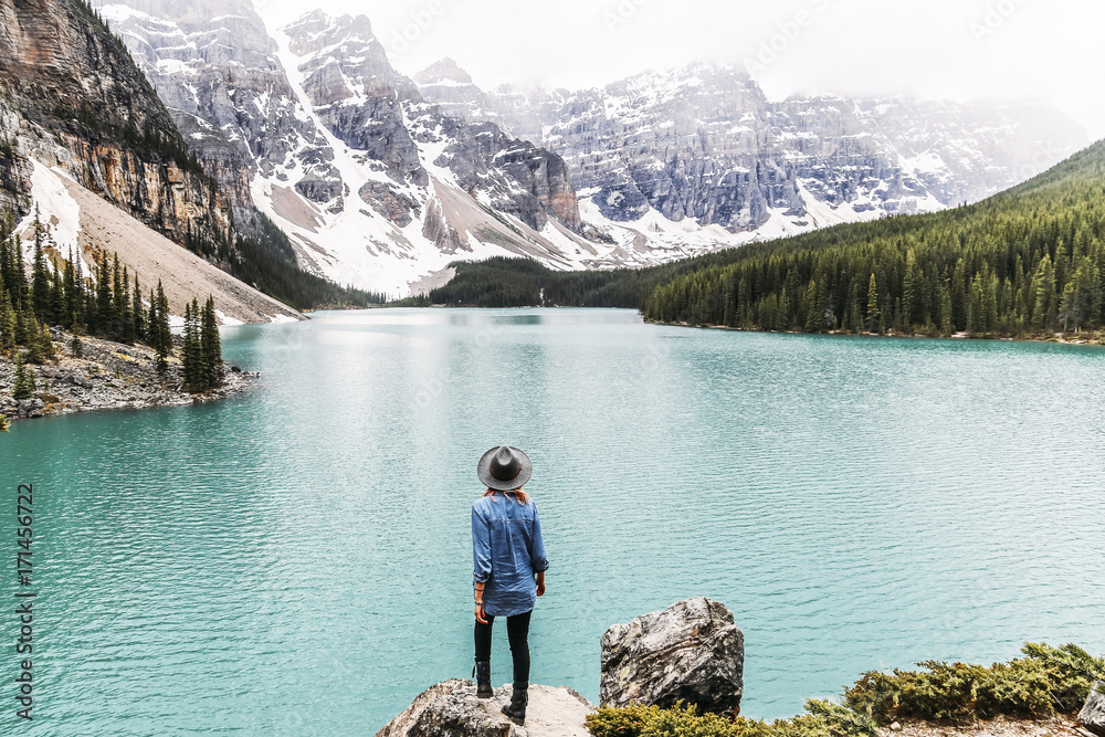 Rear view of woman looking at view of Moraine Lake at Banff National Park Rear view of woman looking at view of Moraine Lake at Banff National Park