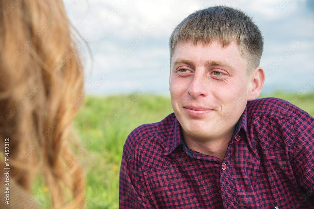 Young couple on a picnic in a beautiful place under the open sky.